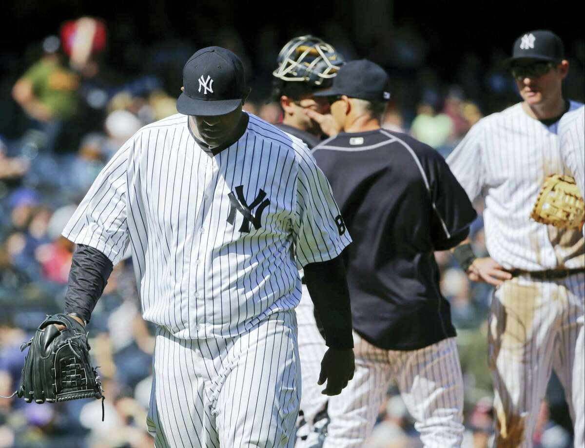 Yankees starting pitcher CC Sabathia, left, leaves the game during the fifth inning.