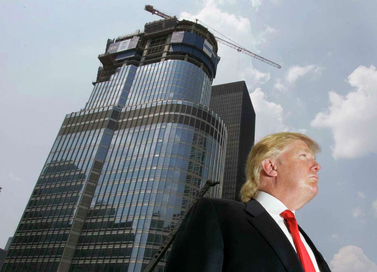 In this photo taken May 24, 2007, Donald Trump is profiled against his 92-story Trump International Hotel & Tower during a news conference on construction progress in Chicago.