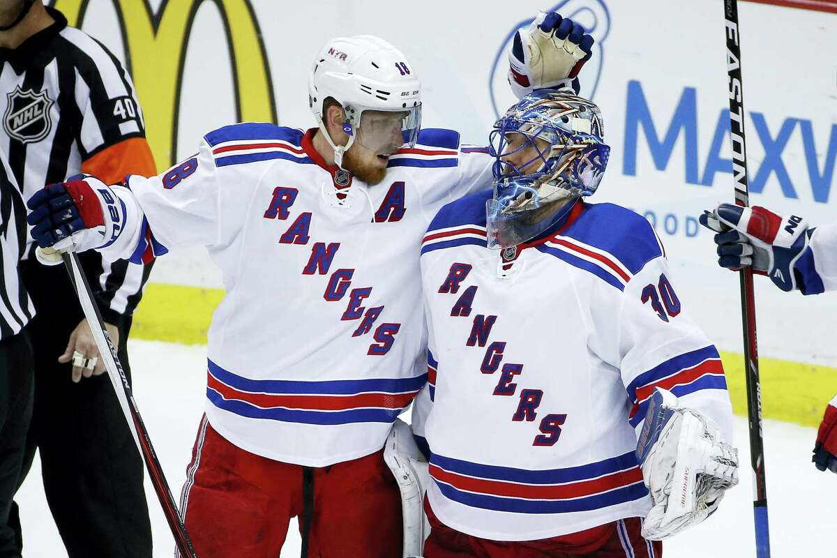 New York Rangers goalie Henrik Lundqvist, right, celebrates a 4-2 win over the Penguins with Marc Staal on Saturday.