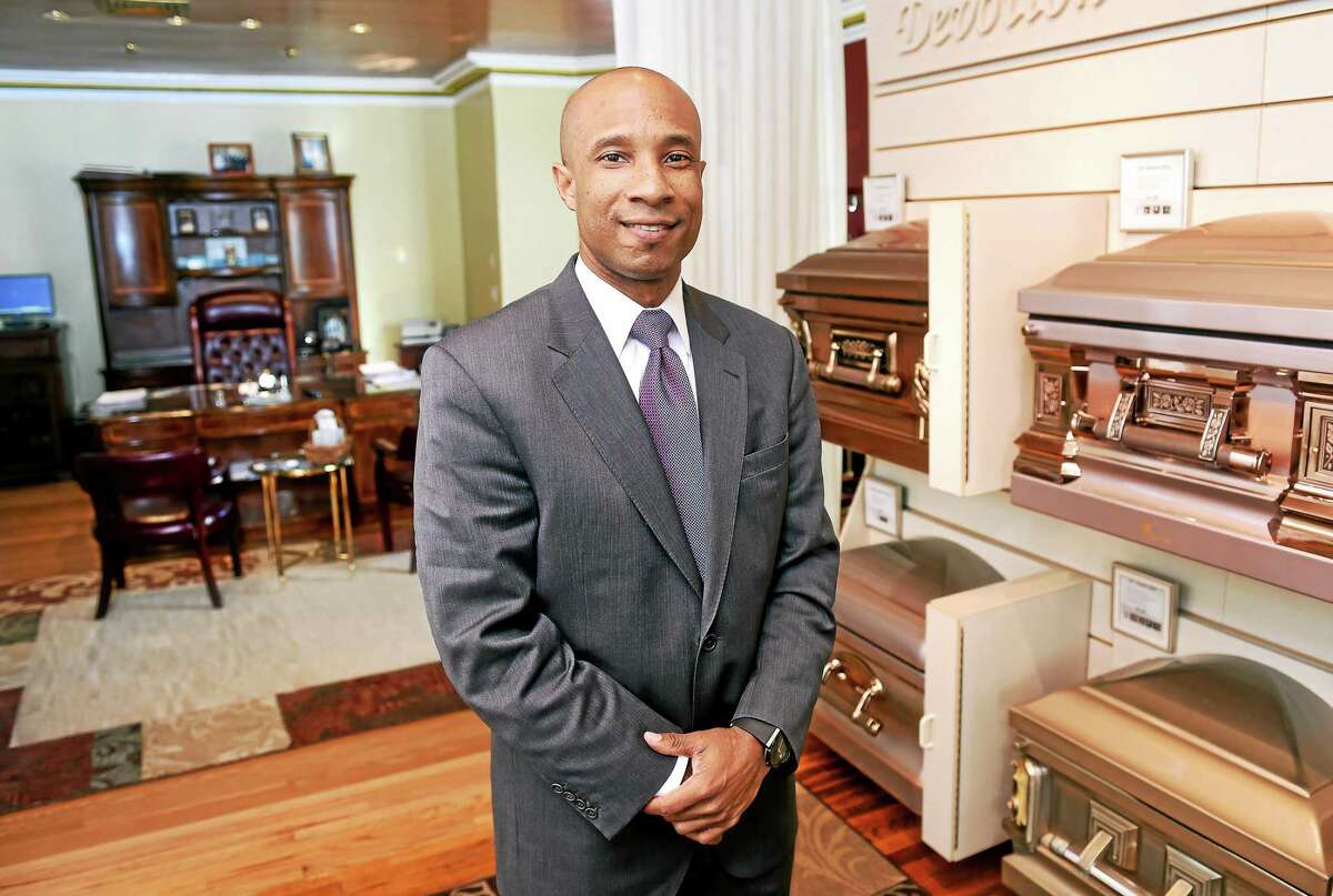 Howard K. Hill, owner of Howard K. Hill Funeral Services, is photographed in his New Haven showroom/office on 1/8/2015.