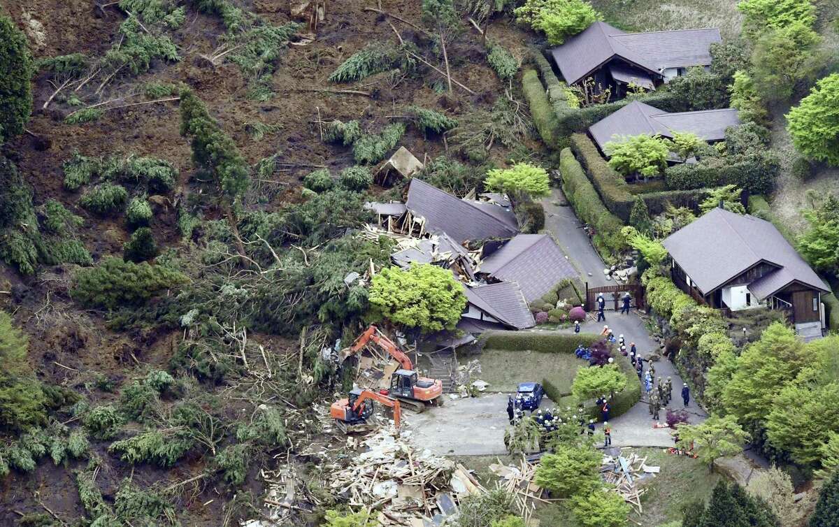 Buildings are collapsed by a landslide caused by an earthquake in Minamiaso village, Kumamoto prefecture, Japan, Saturday, April 16, 2016. The powerful earthquake struck southwestern Japan early Saturday, barely 24 hours after a smaller quake hit the same region.