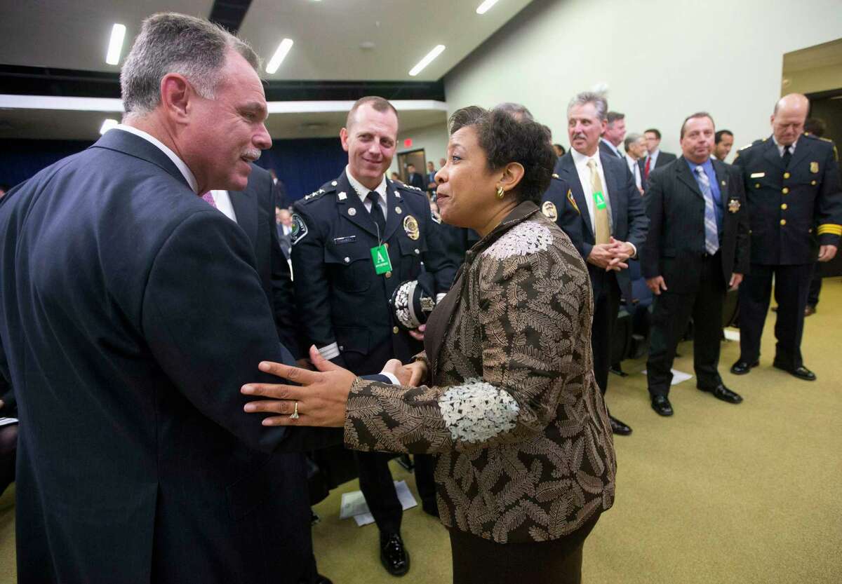 In this Oct. 22, 2015, file photo, Attorney General Loretta Lynch greets Chicago Police Superintendent Garry McCarthy in the Old Executive Office Building on the White House complex in Washington. Chicago Mayor Rahm Emanuel has fired McCarthy after a public outcry over the handling of the case of a black teenager shot 16 times by a white police officer.