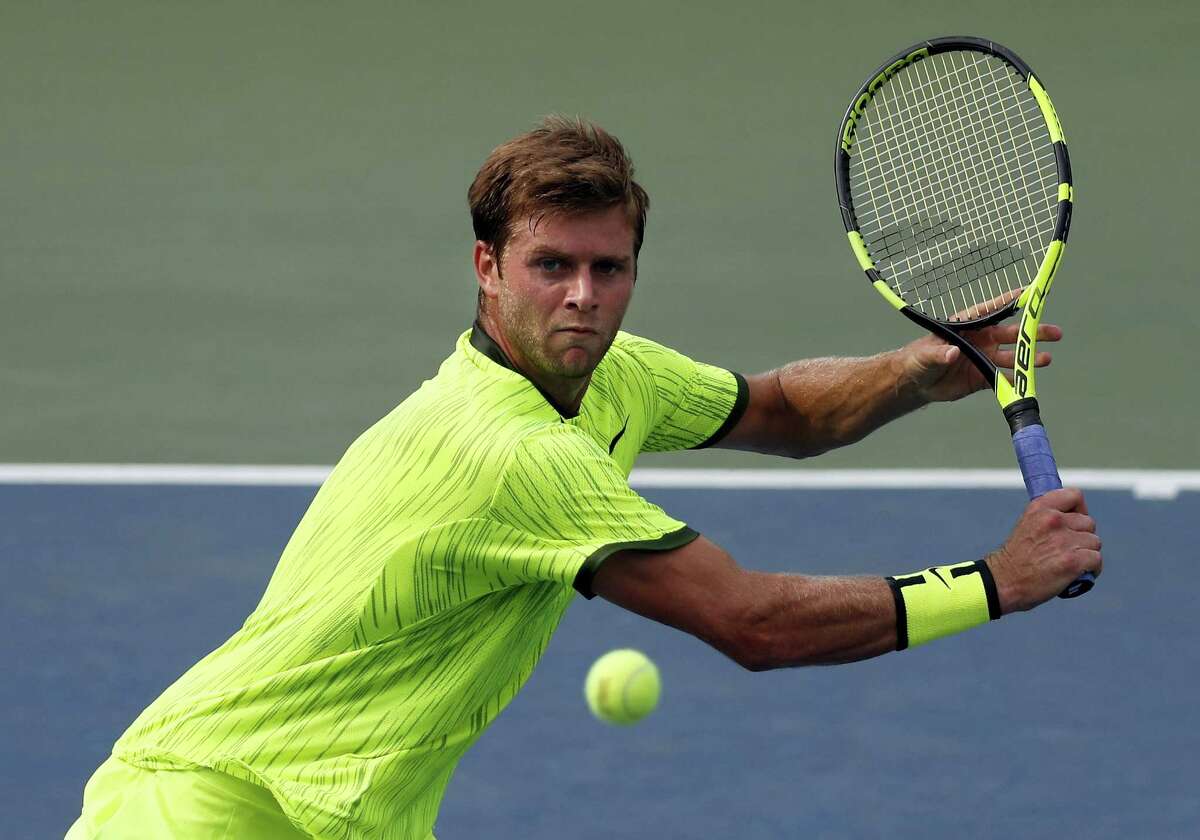 Ryan Harrison of the United States returns a shot to Milos Raonic of Canada during the second round of the U.S. Open tennis tournament Wednesday. Harrison upset the fifth-ranked Raonic in four sets.