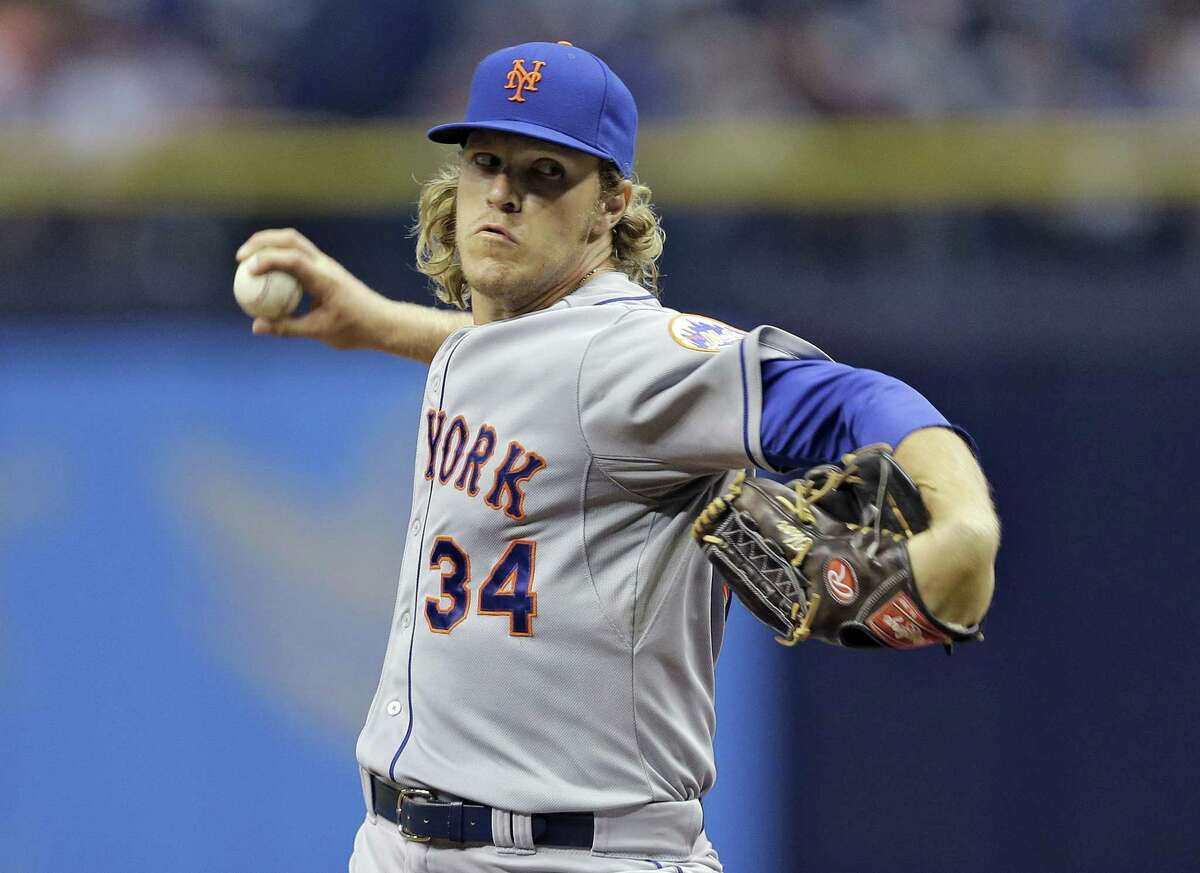 New York Mets starting pitcher Noah Syndergaard delivers to the Tampa Bay Rays during the first inning of an interleague baseball game Saturday, Aug. 8, 2015, in St. Petersburg, Fla. (AP Photo/Chris O'Meara)