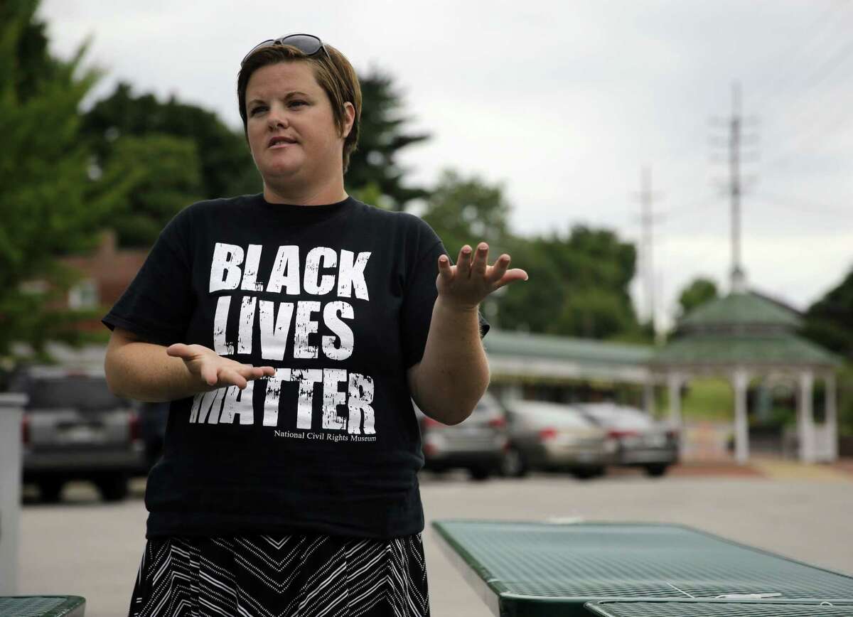 In this July 22, 2015, Emily Davis speaks during an interview in Ferguson, Mo. Davis said she has seen little change for the better in the past year. “People are still being targeted by police officers,” Davis said. “If you talk to people who live on West Florissant, that is still happening. Our city government has not become any more communicative. They have not made any attempt to engage in dialogue — meaningful dialogue — with the citizens, which is not any different than it was a year ago.”