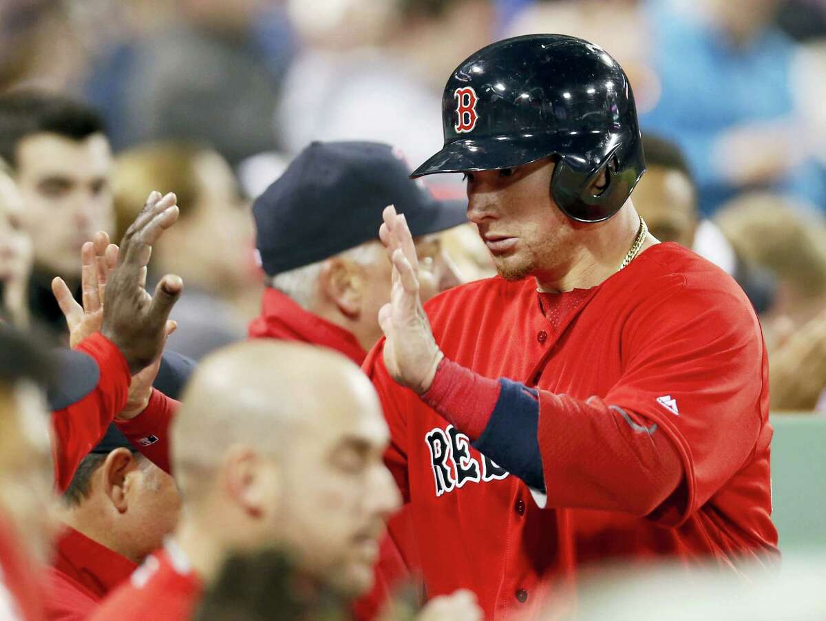 Christian Vazquez is congratulated after scoring on an RBI single by Dustin Pedroia.