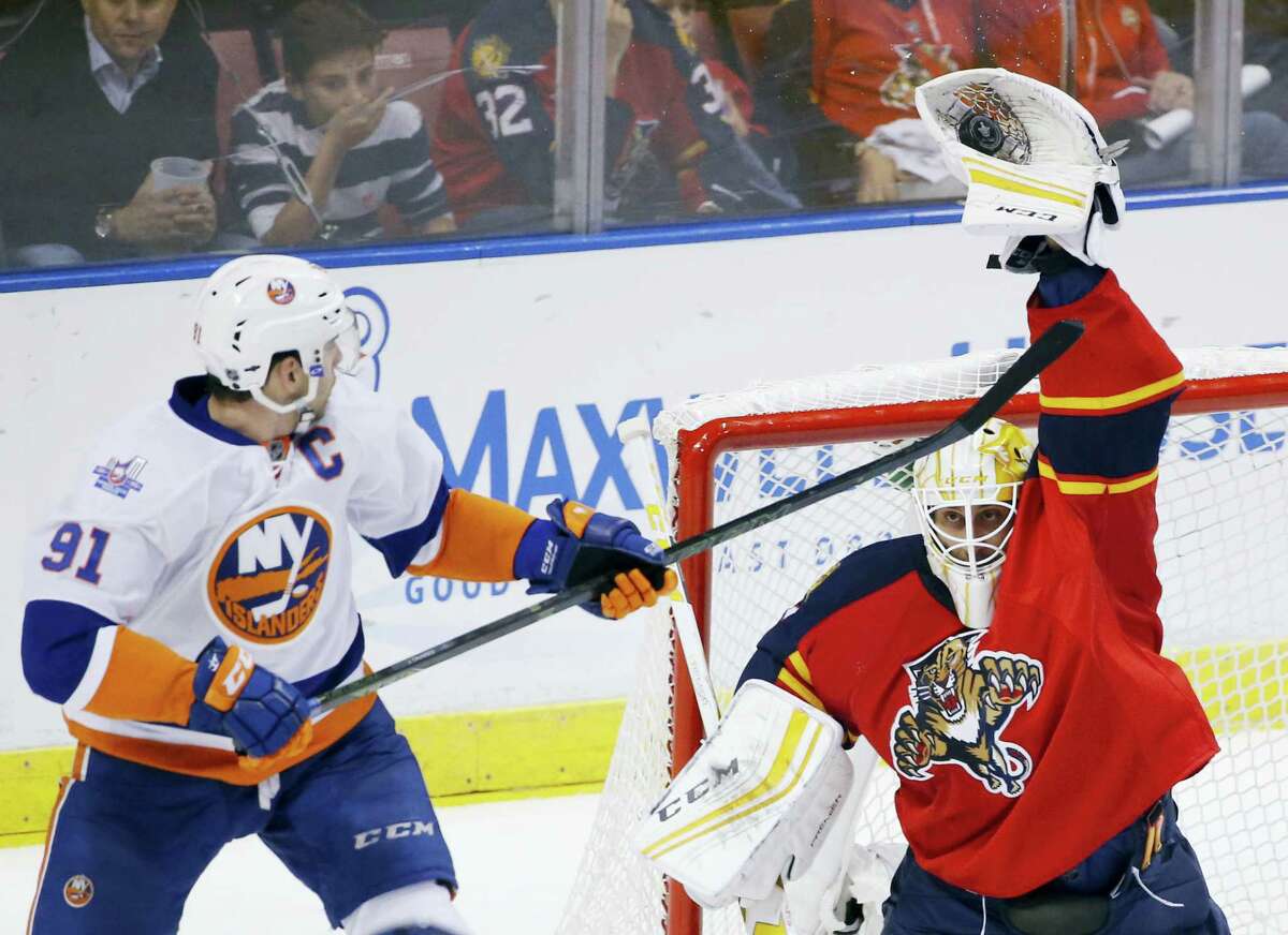 Florida Panthers goalie Roberto Luongo, right, makes a save as Islanders center John Tavares (91) attempts to score during the second period.