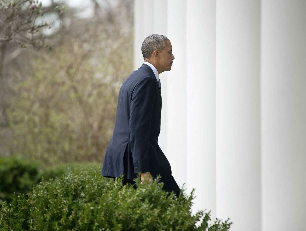 President Barack Obama walks back to the Oval Office after speaking in the Rose Garden of the White House in Washington on April 2.