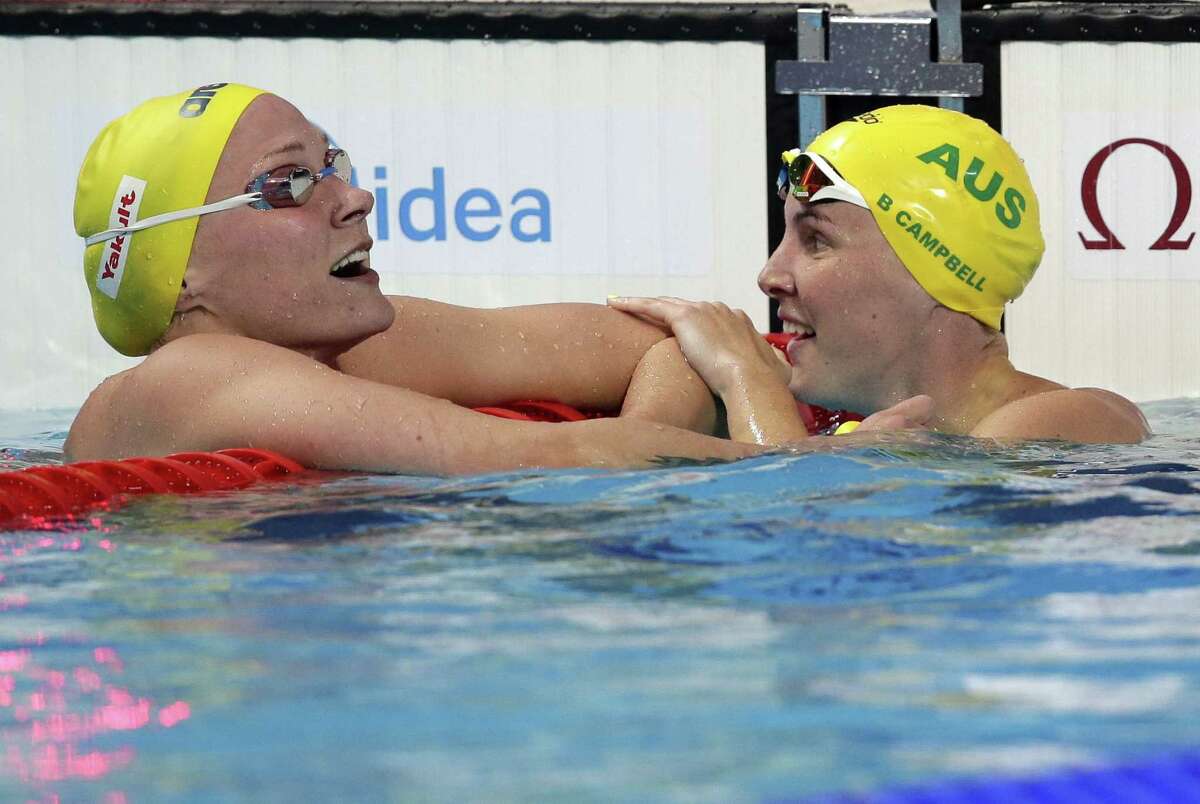 Australia’s Bronte Campbell, right, is congratulated by her sister, Cate, after winning the 100 freestyle final at the Swimming World Championships on Friday in Kazan, Russia. Cate Campbell won the bronze medal.