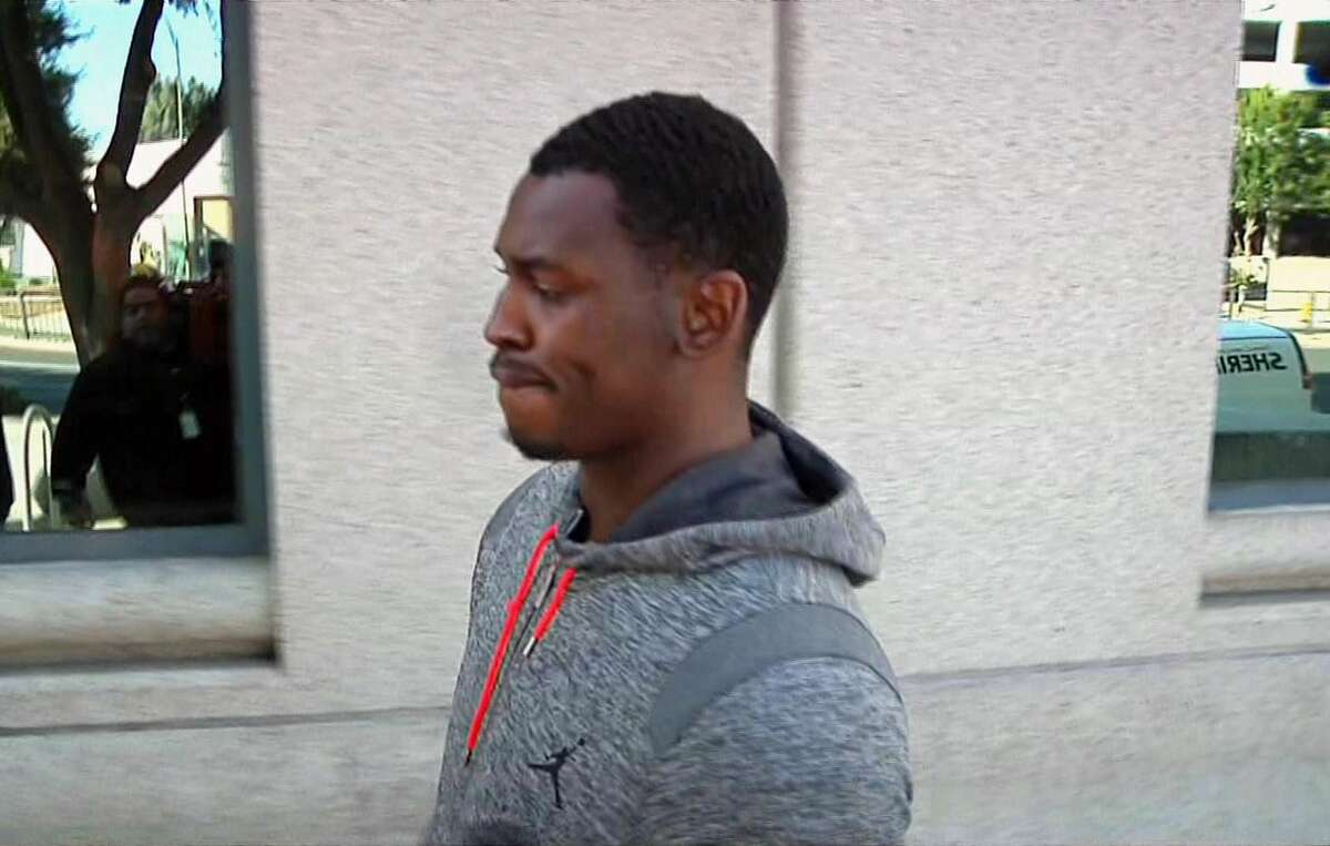 In this image made from video and provided by KNTV, former San Francisco 49ers linebacker Aldon Smith walks past cameras after being released from the Santa Clara County Jail on Friday in San Jose, Calif. Santa Clara Police arrested Smith on charges of hit and run, drunken driving and vandalism.