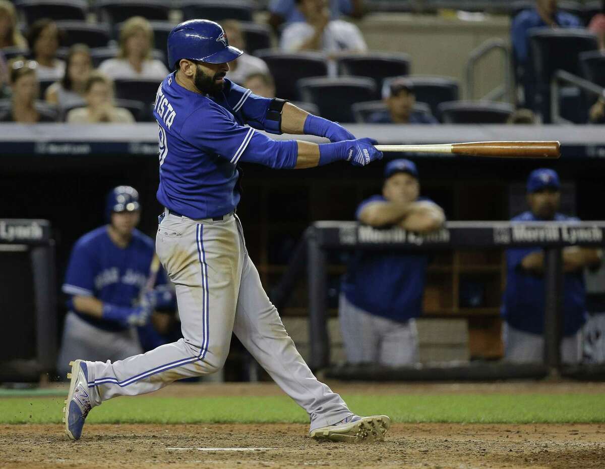 Blue Jays right fielder Jose Bautista follows through on a home run in the 10th inning on Friday.