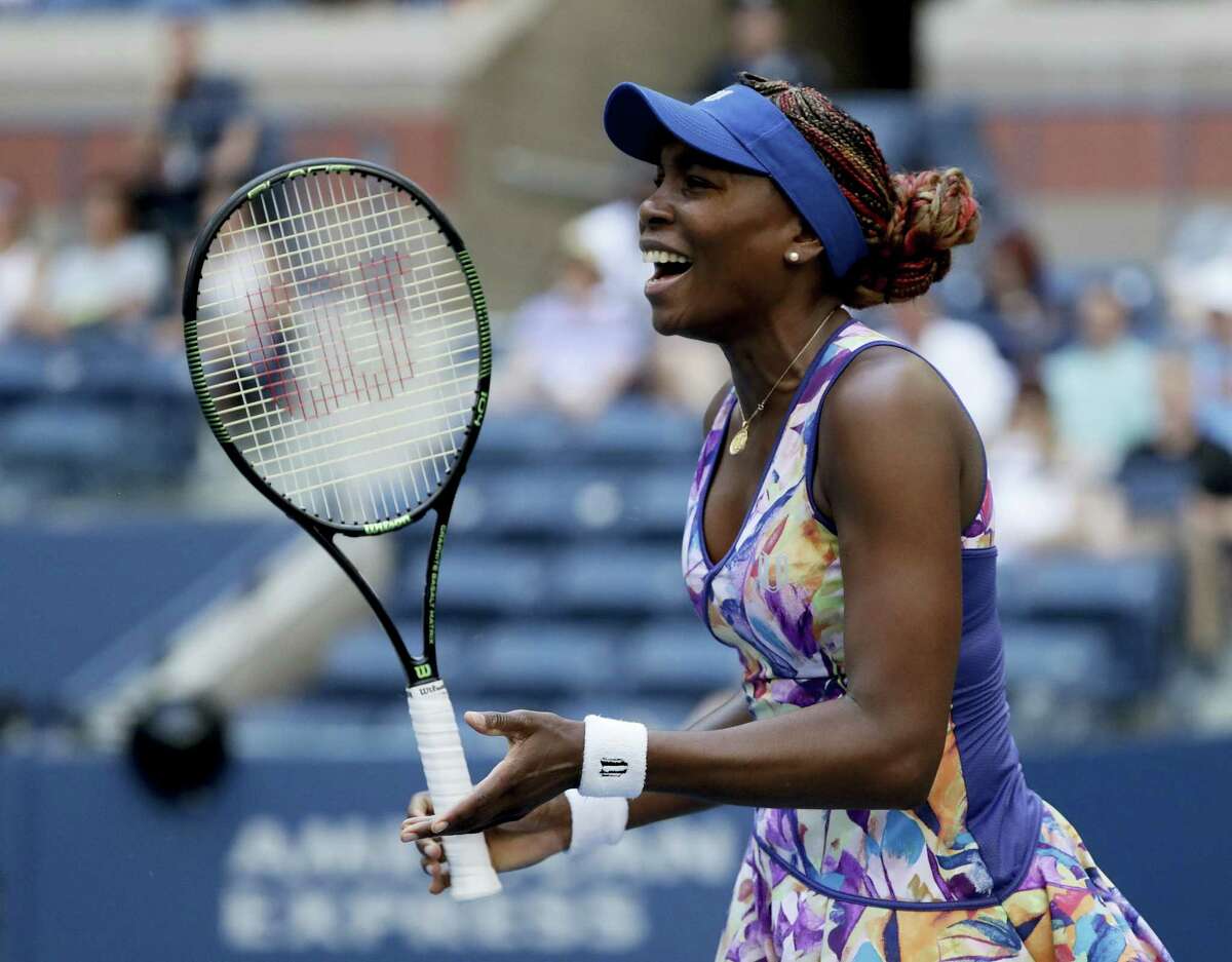 Venus Williams reacts after a shot to Kateryna Kozlova during the first round of the U.S. Open tennis tournament Tuesday. Williams won in three sets.