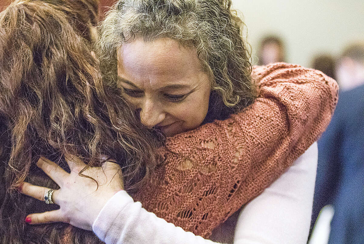 Jack McCullough’s stepdaughter Janey O’Connor hugs her cousin Jenn Houton after Judge William Brady released McCullough and granted him a new trial during a hearing in the DeKalb County Courthouse on Friday, April 15, 2016 in Sycamore, Ill. McCullough who a prosecutor says was wrongly convicted in the 1957 killing of an Illinois schoolgirl was released Friday shortly after a judge vacated his conviction, meaning that one of the oldest cold cases to be tried in U.S. history has officially gone cold again.