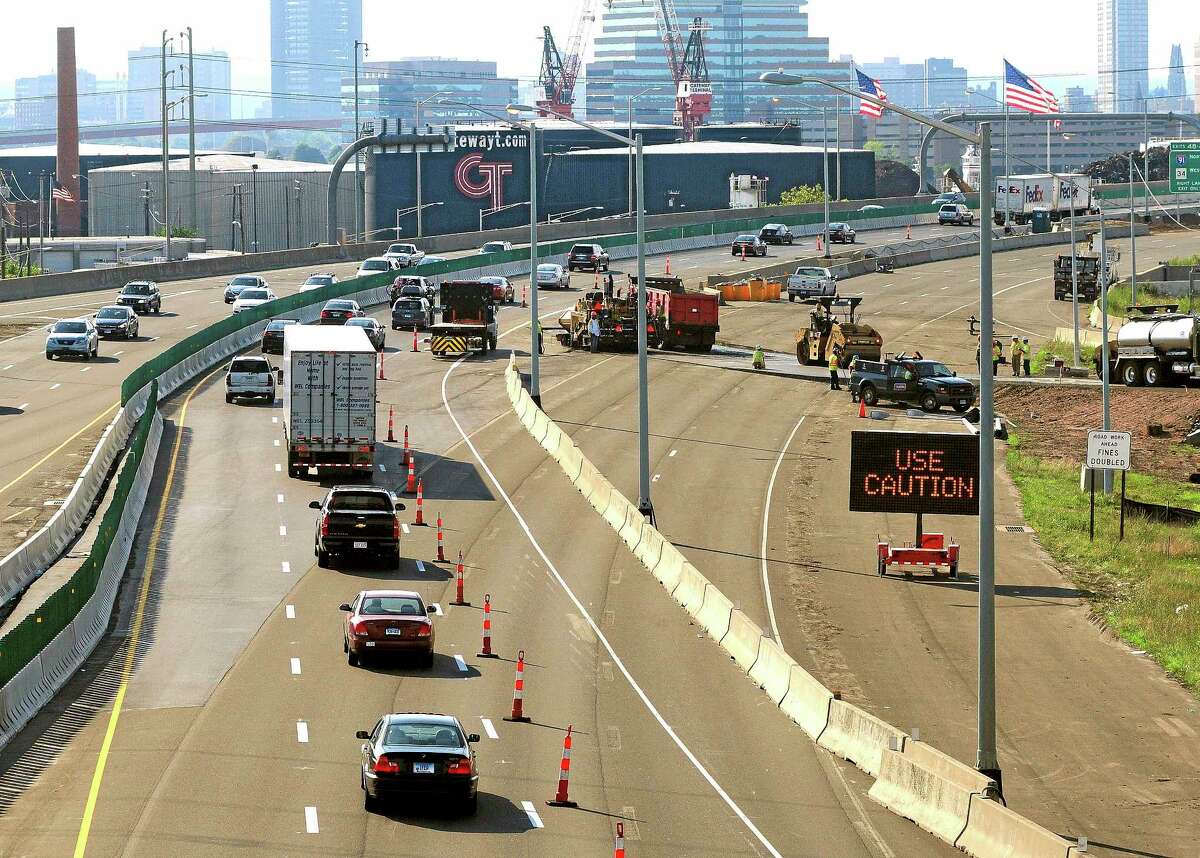 In this July 27, 2013, photo, traffic moves along southbound Interstate 95 in New Haven after the traffic pattern was diverted from the old Pearl Harbor Memorial Bridge approach, right, to the new span.