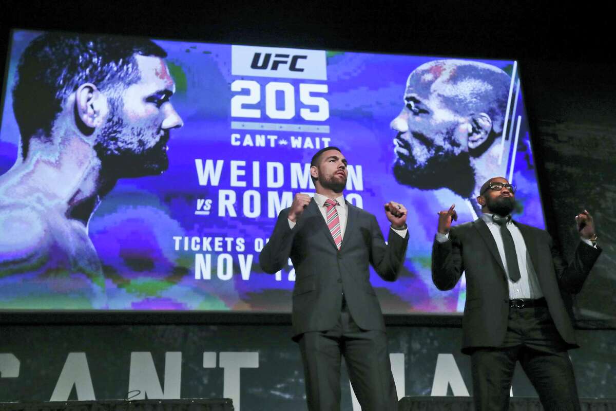 UFC middleweight fighters Chris Weidman, left, and Yoel Romero pose for photos during a news conference for UFC 205 in New York. Weidman and Romero are on the first major UFC card to be held in New York after the state legislature legalized the sport earlier in 2016.