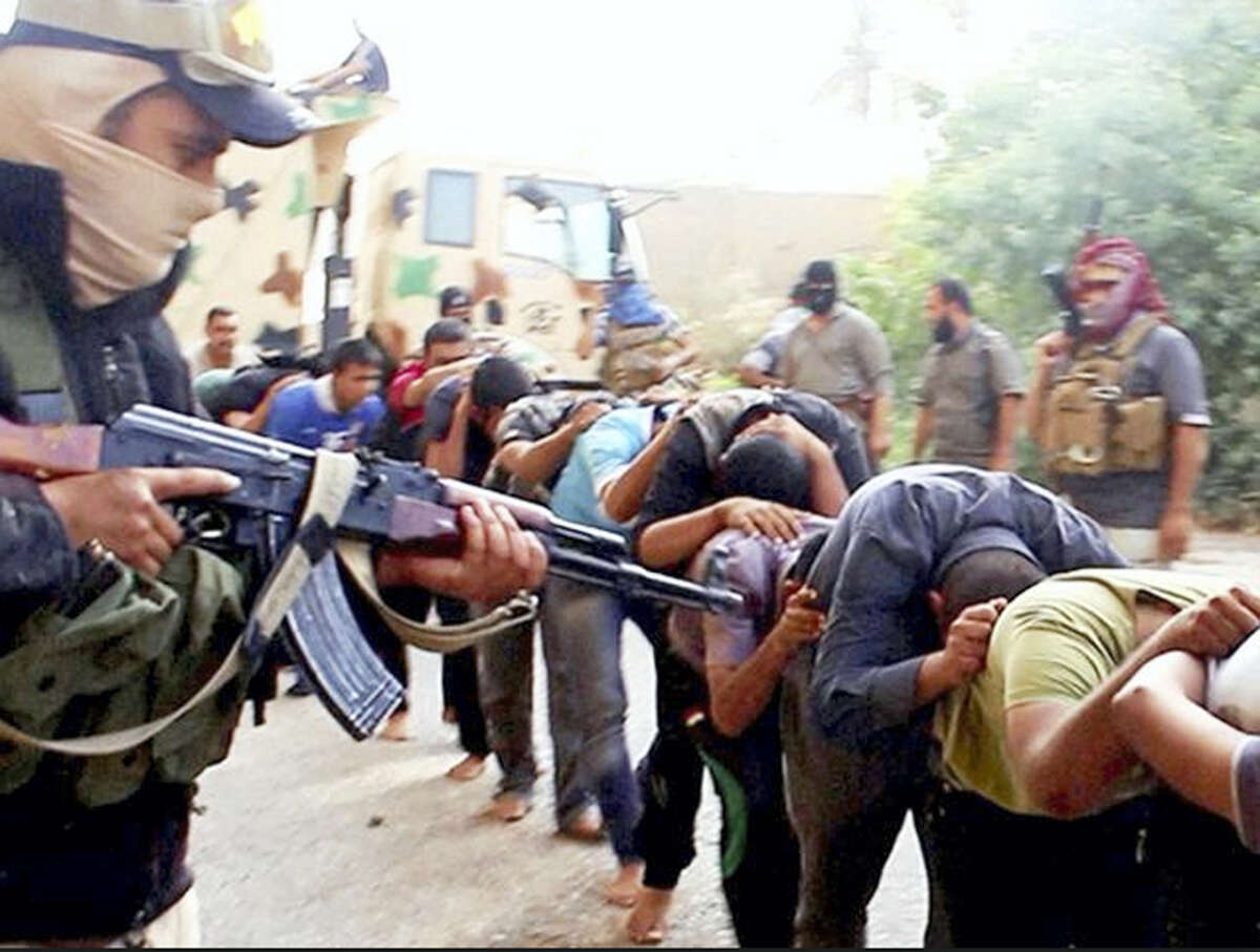 This image posted online by Islamic State militants on June 14, 2014 shows Iraqi cadets captured by IS moments before they were killed in Tikrit, Iraq. Their bodies are believed to be in one of the many mass graves left behind by Islamic State extremists. An analysis by The Associated Press has found 72 such graves in Iraq and Syria, and many more are expected to be discovered as the group loses territory.