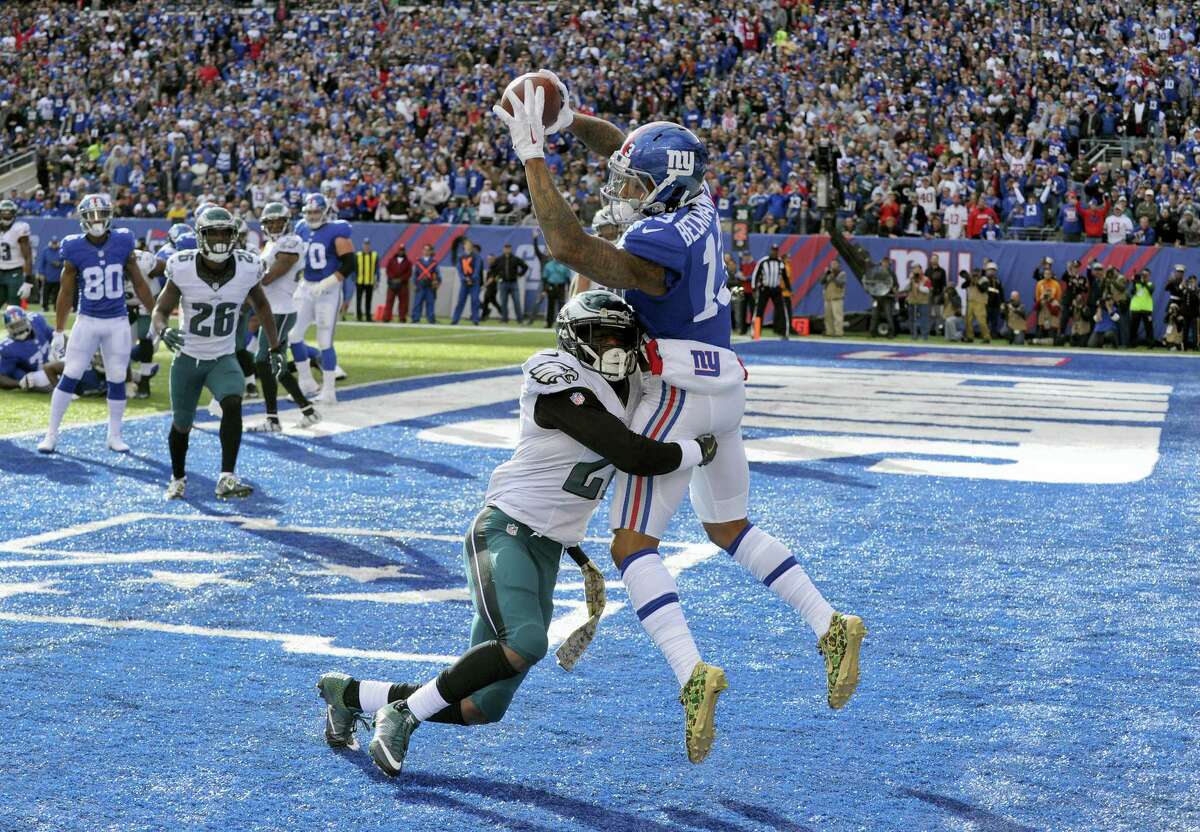 Giants wide receiver Odell Beckham catches a pass for a touchdown as he is hit by Eagles cornerback Leodis McKelvin during the second quarter Sunday.