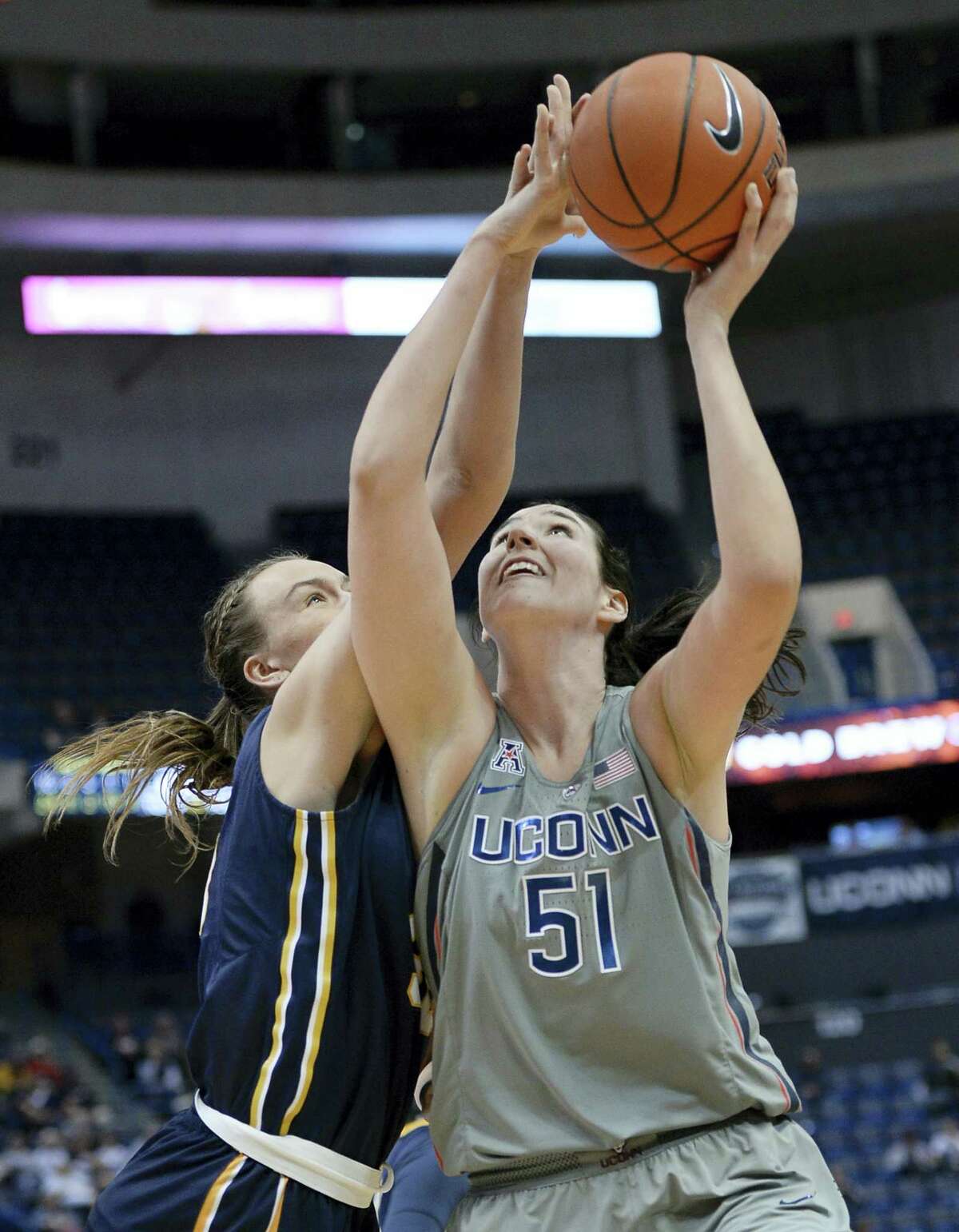 UConn’s Natalie Butler shoots as Pace’s Kirsten Dodge, left, defends in the second half on Sunday.