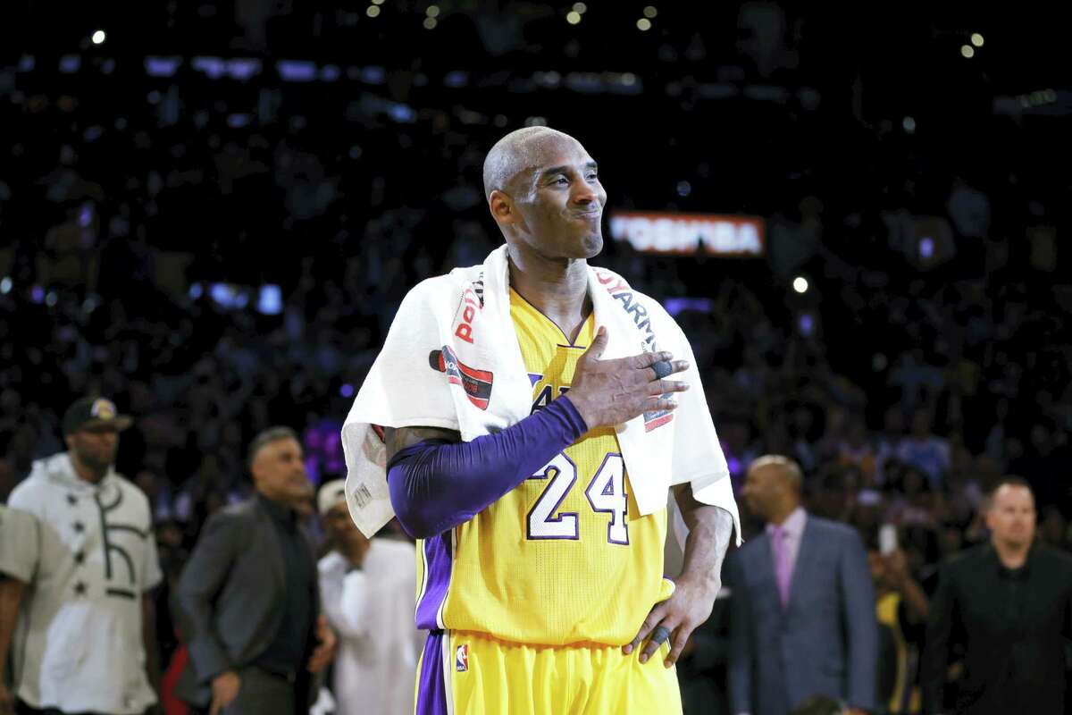 Kobe Bryant pounds his chest after playing the final NBA game of his career on Wednesday in Los Angeles.