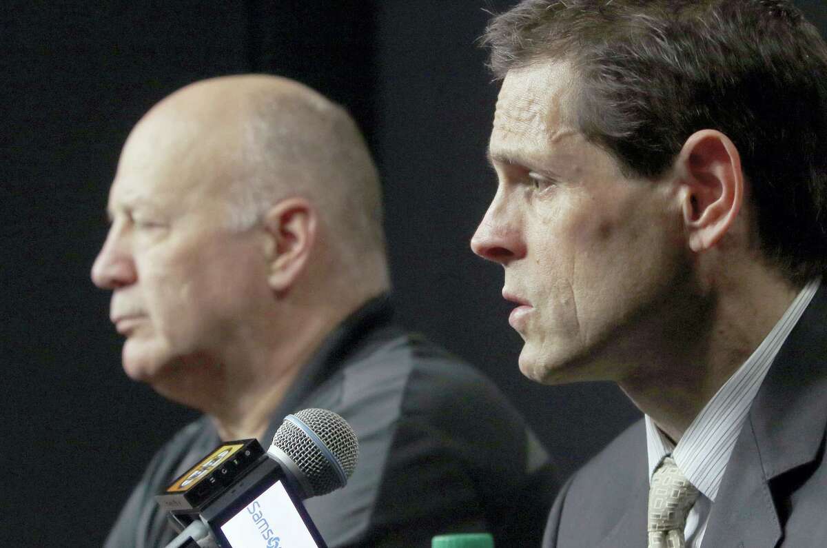 Bruins general manager Don Sweeney, right, speaks alongside head coach Claude Julien at a news conference Thursday in Boston.