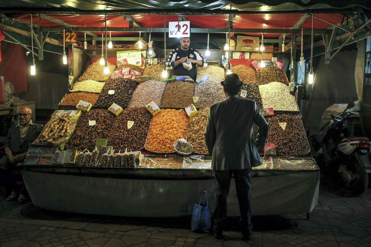 A man shops for dry fruits at a stall in the landmark Jemaa el-Fnaa square and market, in Marrakesh, Morocco on Nov. 5, 2016. The Climate Conference, known as the COP22, starts Monday in Marrakech and is expected to attract hundreds of participants and state representatives.
