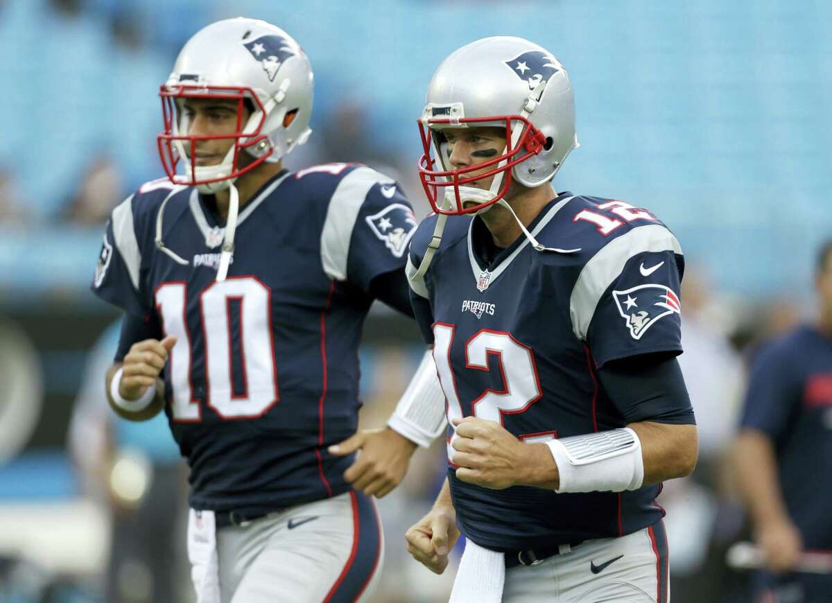 New England Patriots quarterbacks Tom Brady (12) and Jimmy Garoppolo.