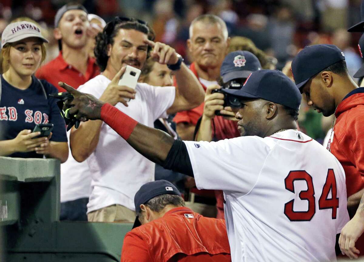 Boston Red Sox designated hitter David Ortiz (34) points to fans while going into the dugout after the Red Sox defeated the Minnesota Twins in a baseball game at Fenway Park, Thursday in Boston.