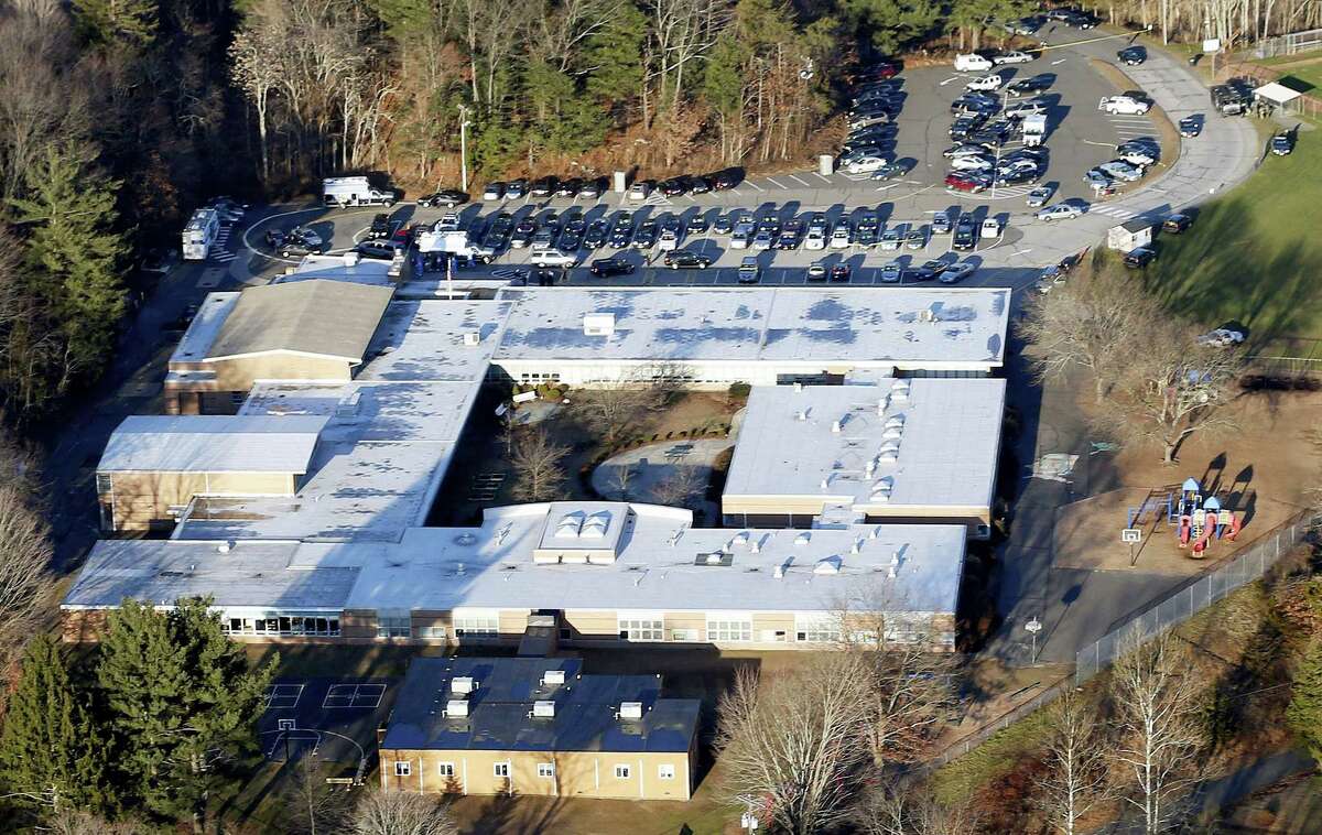 This Dec. 14, 2012 aerial file photo shows Sandy Hook Elementary School in Newtown, Conn. Contractors demolishing Sandy Hook Elementary School are being required to sign confidentiality agreements forbidding public discussion of the site, photographs or disclosure of any information about the building where 26 people were fatally shot in December 2012.