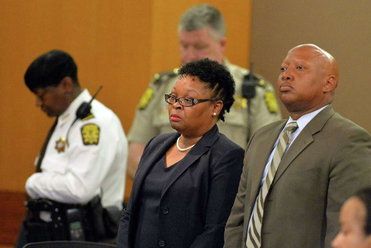 Former Dunbar Elementary teacher Diane Buckner-Webb, center, stands with her defense attorney Kevin Franks after a jury found her guilty in the Atlanta Public Schools test-cheating trial, Wednesday, April 1, 2015, in Atlanta. Buckner-Webb and 10 other former Atlanta Public Schools educators accused of participating in a test cheating conspiracy that drew nationwide attention were convicted Wednesday of racketeering charges.