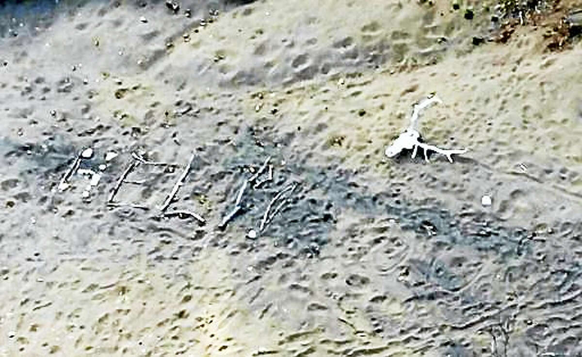 This aerial photo taken Saturday, April 9, 2016, and provided by Arizona Department of Public Safety shows, a “help” sign made by Ann Rodgers, 72, in the White Mountains of eastern Arizona. Rodgers got lost after her hybrid car ran out of gas and battery on March 31. She survived in the forest for nine days by drinking pond water and eating plants. Authorities came across her dog April 9, and a DPS flight crew spotted a “help” signal made of sticks and rocks on the ground. Rodgers had left the area, but she was found on a reservation that’s home to the White Mountain Apache Tribe after starting a signal fire.