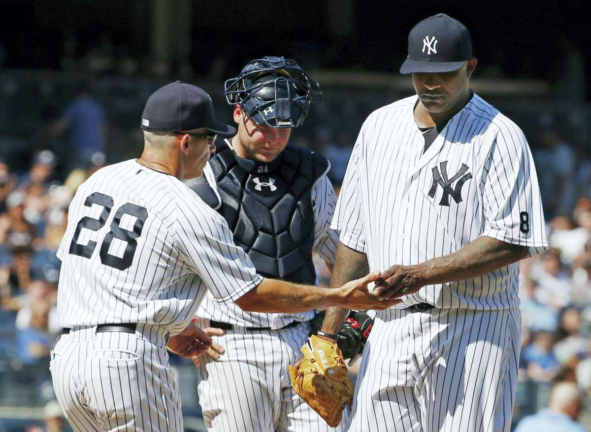 Yankees manager Joe Girardi takes the ball from CC Sabathia in the seventh inning on Sunday.