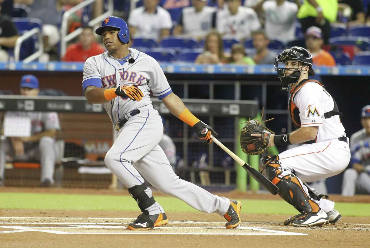 New York Mets batter Yoenis Cespedes hits a first inning double in front of Miami Marlins catcher J.T. Realmuto.