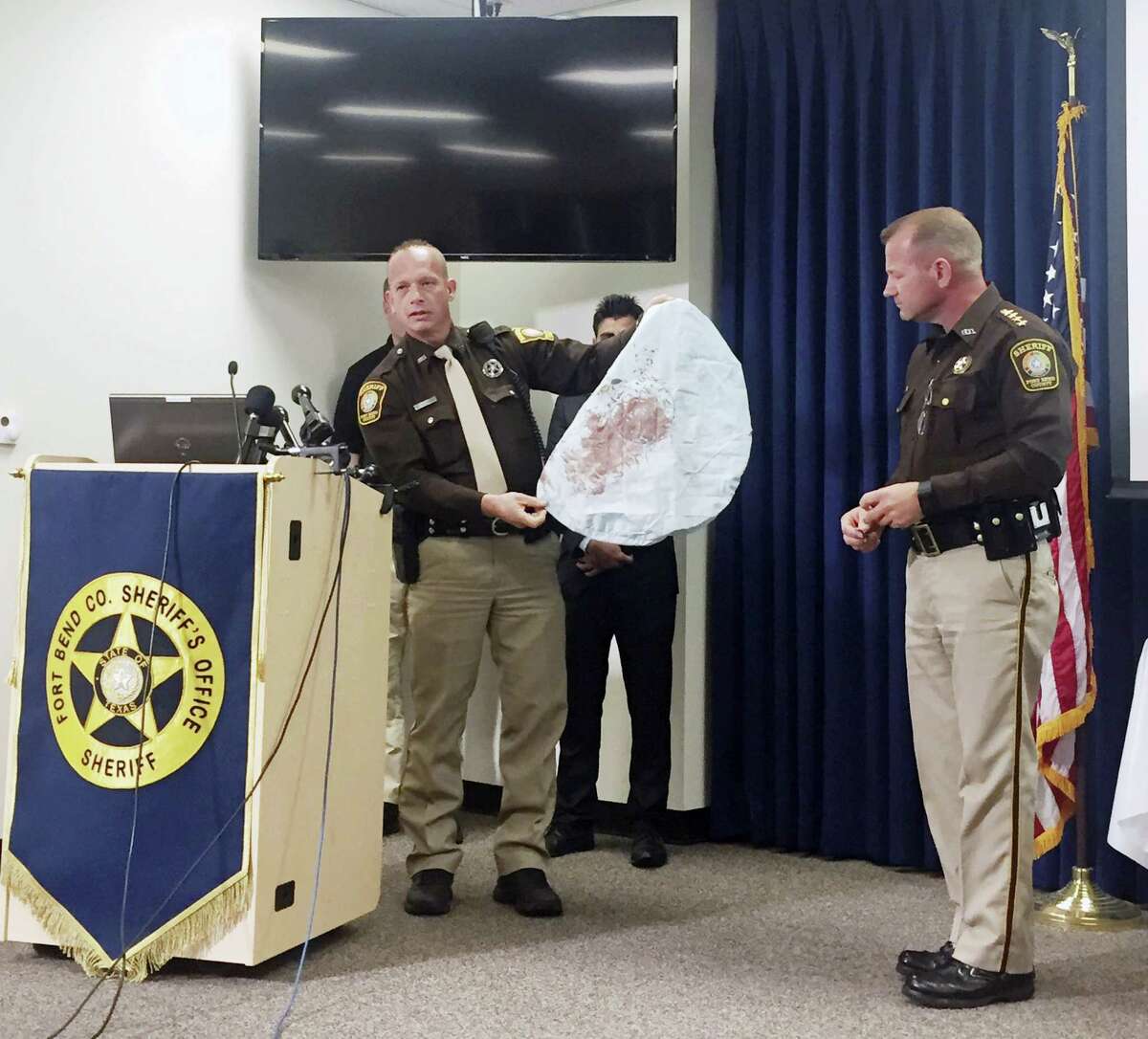 Deputy Danny Beckworth, who investigated the crash site, displays part of a defective airbag believed to have killed 17-year-old Huma Hanif during a news conference April 7 in Houston. The brother of a 17-year-old Texas girl who was killed last week when an exploding Takata air bag sent a shard of metal into her neck said he never received a recall notice about his 2002 Honda Civic.