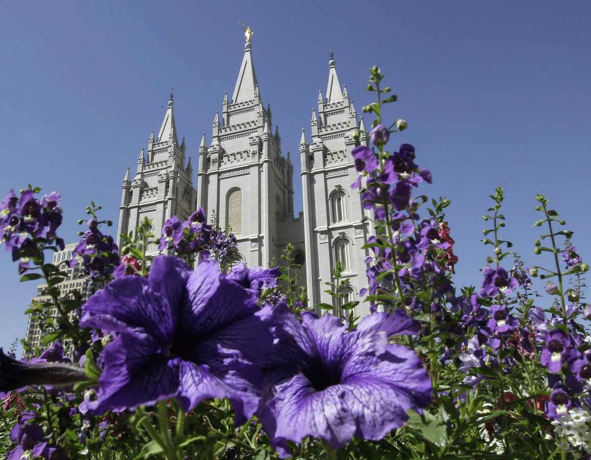 This Sept. 3, 2014, file photo shows flowers blooming in front of the Salt Lake Temple, at Temple Square, in Salt Lake City.