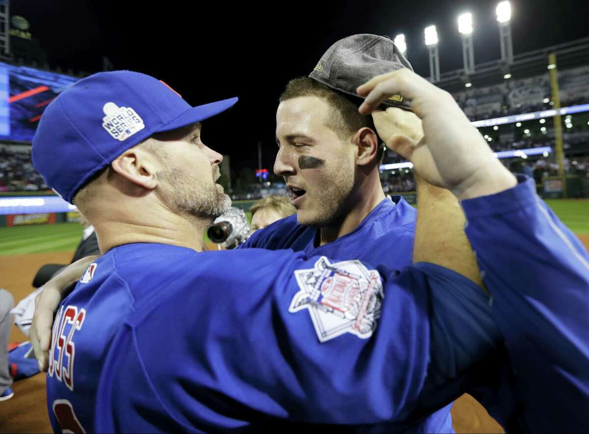 Chicago Cubs’ David Ross, left, and Anthony Rizzo celebrate after Game 7 of the Major League Baseball World Series against the Cleveland Indians Thursday, Nov. 3, 2016, in Cleveland. The Cubs won 8-7 in 10 innings to win the series 4-3.