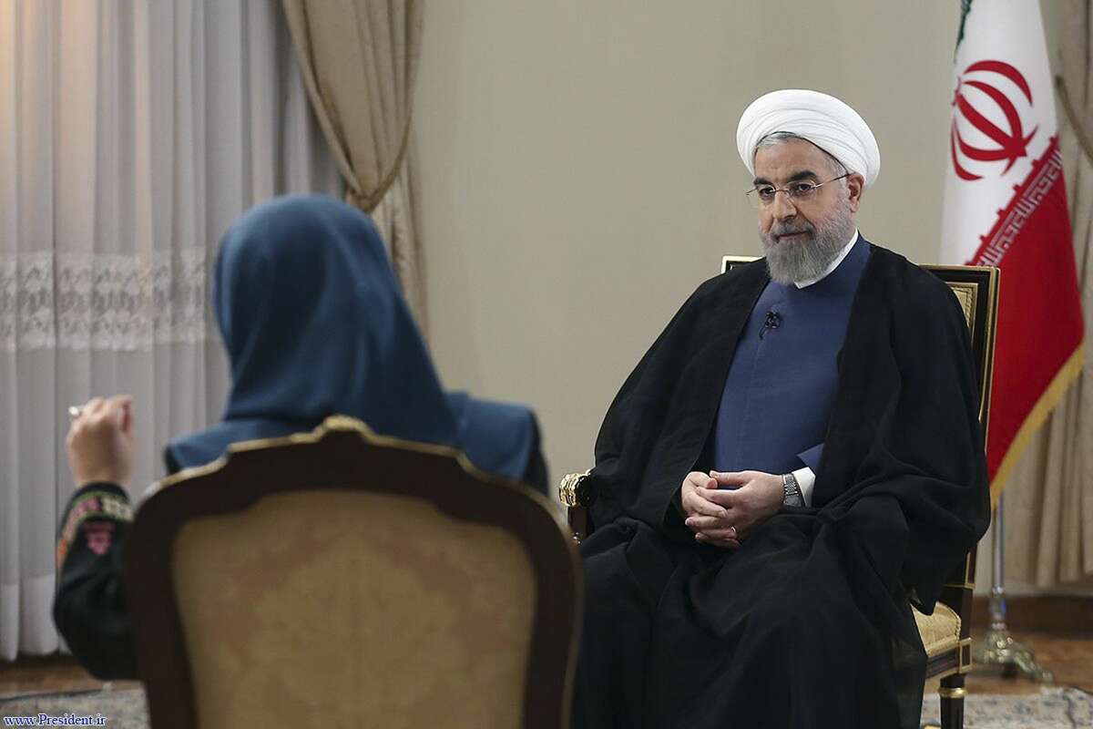 In this photo released by the official website of the office of the Iranian Presidency on Aug. 2, 2015, Iran’s President Hassan Rouhani, right, listens to a question in an interview with the state-run TV at the presidency office in Tehran, Iran.