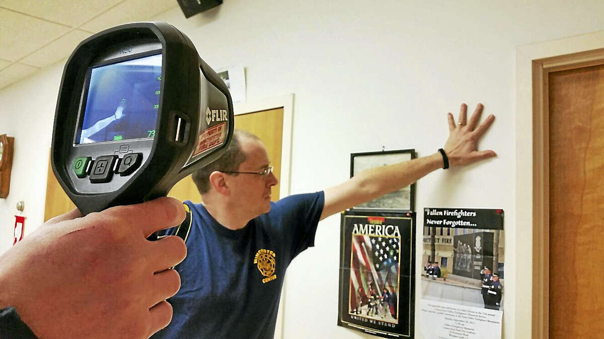 N.F. Ambery photo Members of the Winchester Volunteer Fire Department prepared to demonstrate a heat impression left by a hand using a thermal imaging camera.
