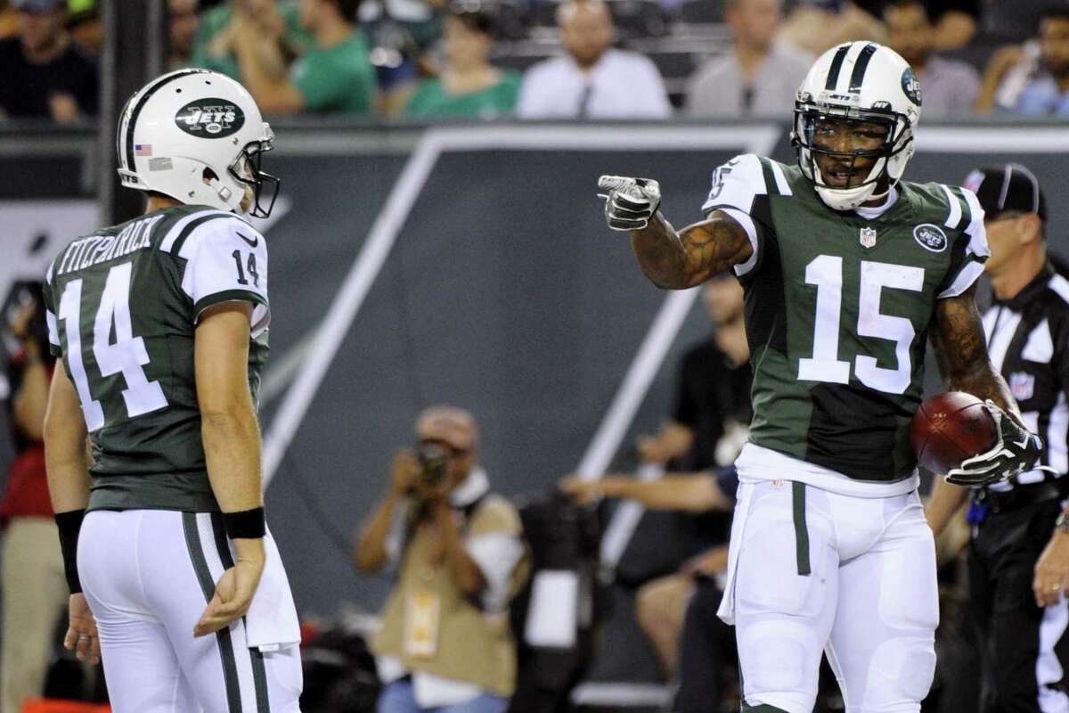 Jets wide receiver Brandon Marshall (15) gestures to quarterback Ryan Fitzpatrick after they scored on a two point conversion during a preseason game against the Falcons.