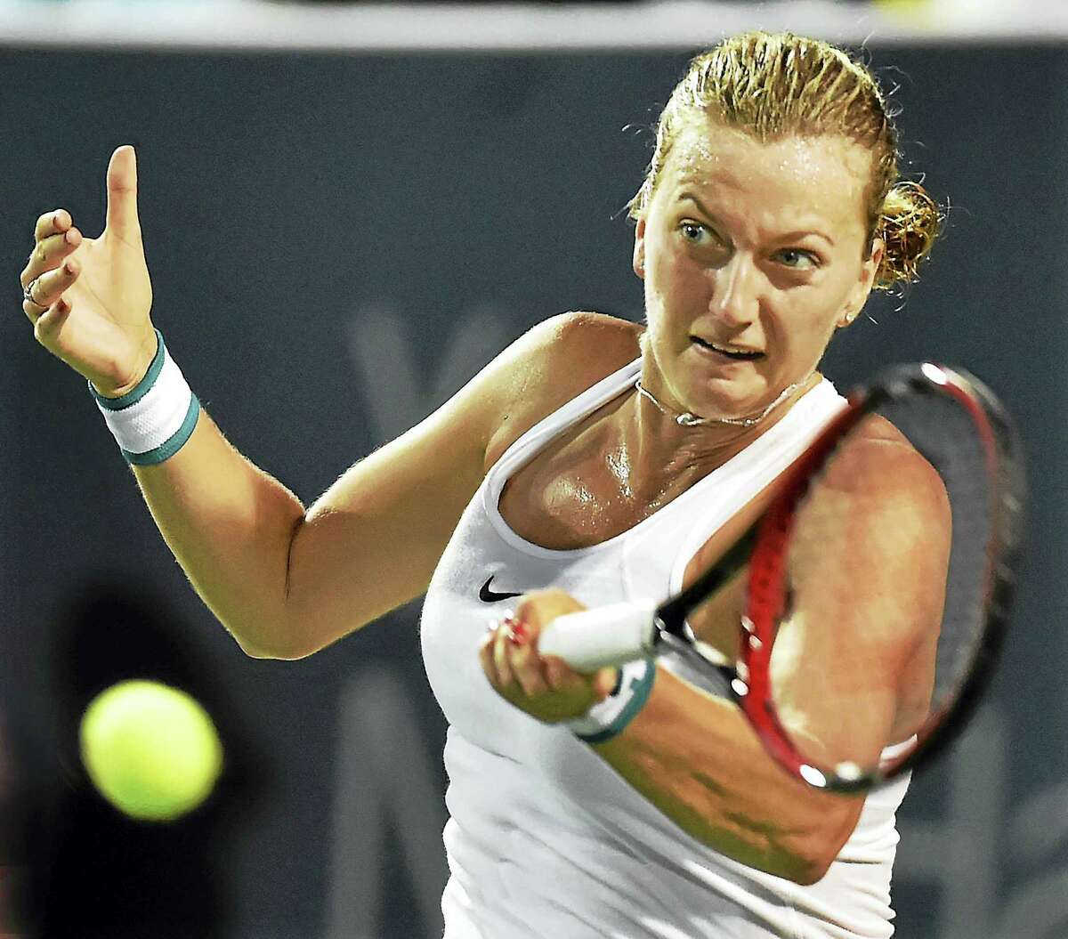 Petra Kvitova returns a shot against Agnieszka Radwanska.