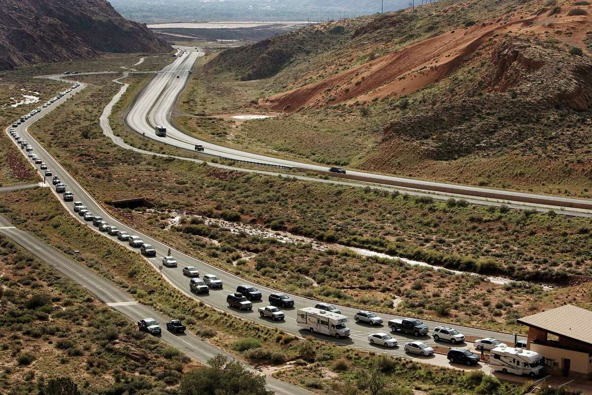Vehicles wait at the entrance to Arches National Park in Utah.