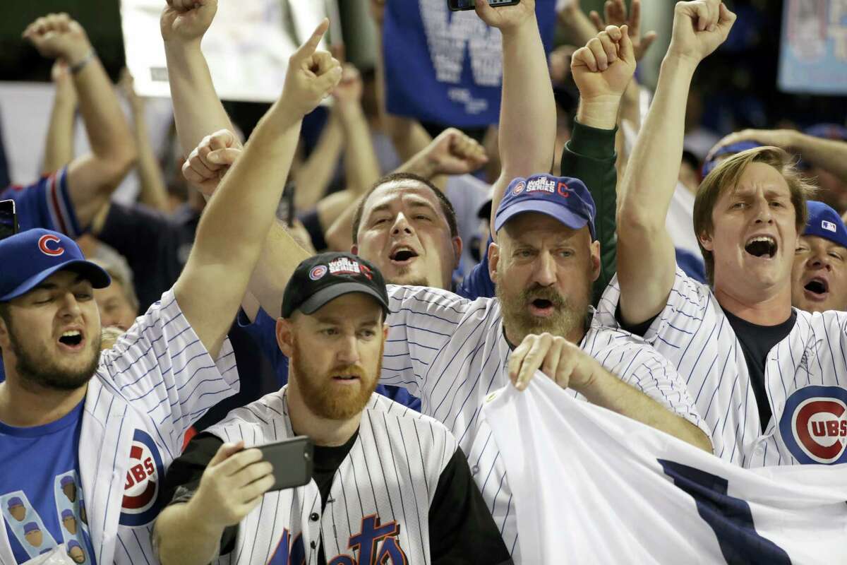Chicago Cubs fans cheer at Progressive Field after Game 6 of the World Series. The Cubs won 9-3 to tie the series 3-3.
