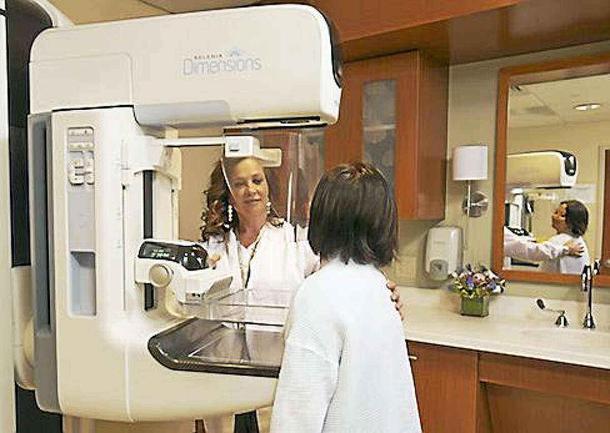 Mammography technologist Yolanda Jerez assists a patient undergoing 3D mammography at Stamford Hospital.