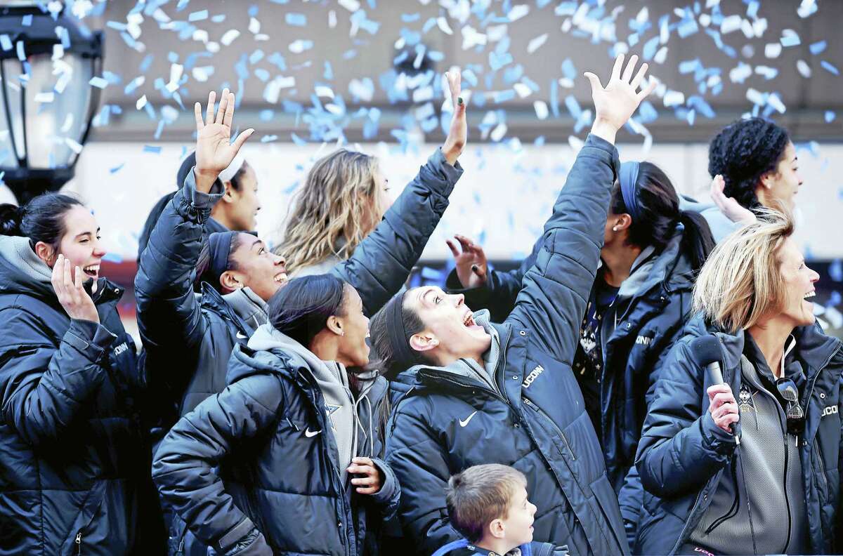 (Arnold Gold-New Haven Register) UCONN's Breanna Stewart (center) and her teammates react to confetti blanketing the area at a victory rally for the 2016 NCAA Women's Basketball National Championship team in front of the XL Center in Hartford on 4/10/2016.
