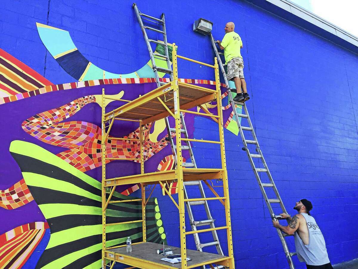Ben Lambert - The Register CitizenA mural by Danielle Mailer is being installed on the rear wall of Staples in Torrington, overlooking the Naugatuck River.