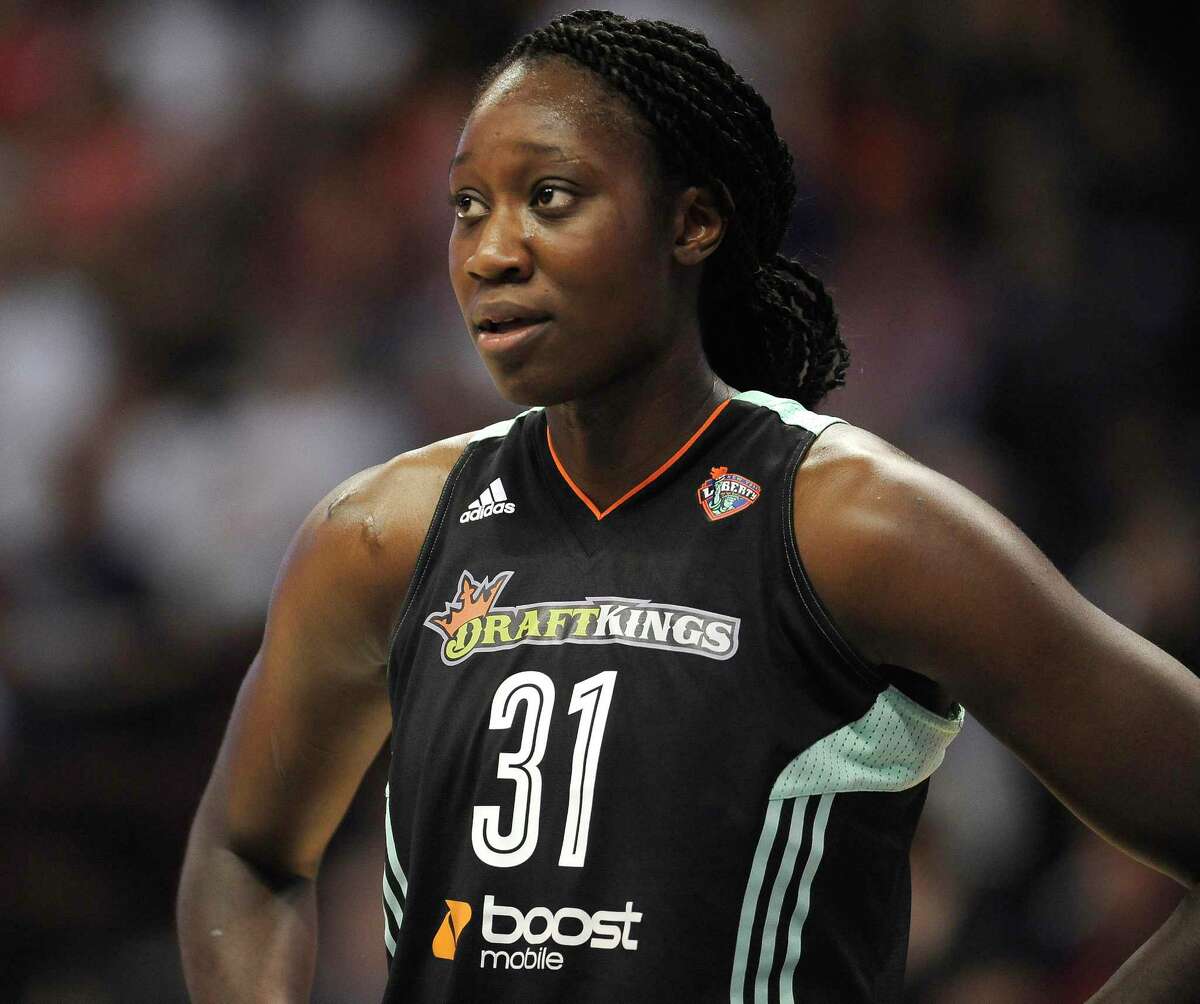 In this Aug. 14, 2015 photo, New York Liberty’s center Tina Charles wears a jersey printed with the logo of the daily fantasy sports company DraftKings during the first half of a WNBA basketball game in Uncasville, Conn.