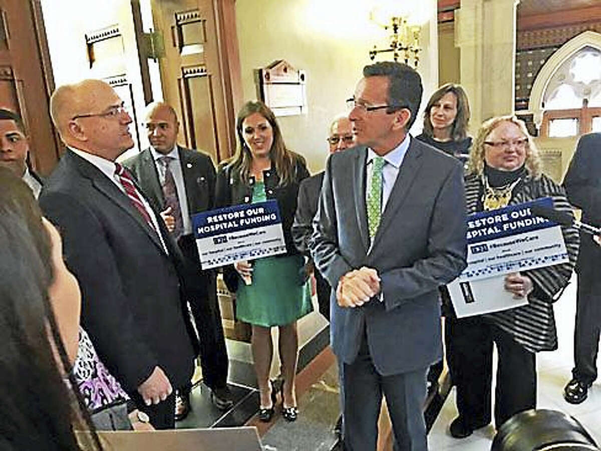 Gov. Dannel P. Malloy is confronted in March outside his office by the CEO of Day Kimball Hospital.