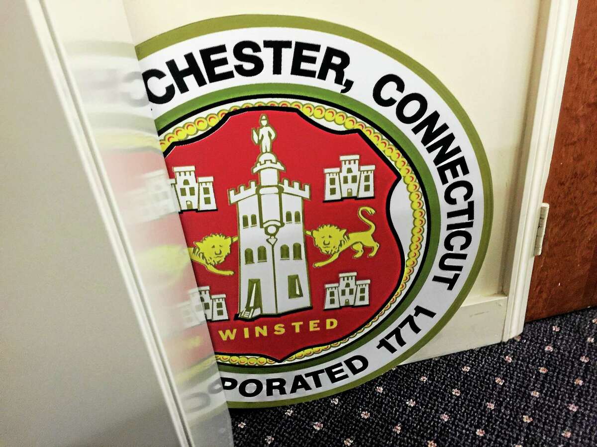 A physical representation of the Winsted/Winchester Town Seal, slightly obscured, in Town Hall.