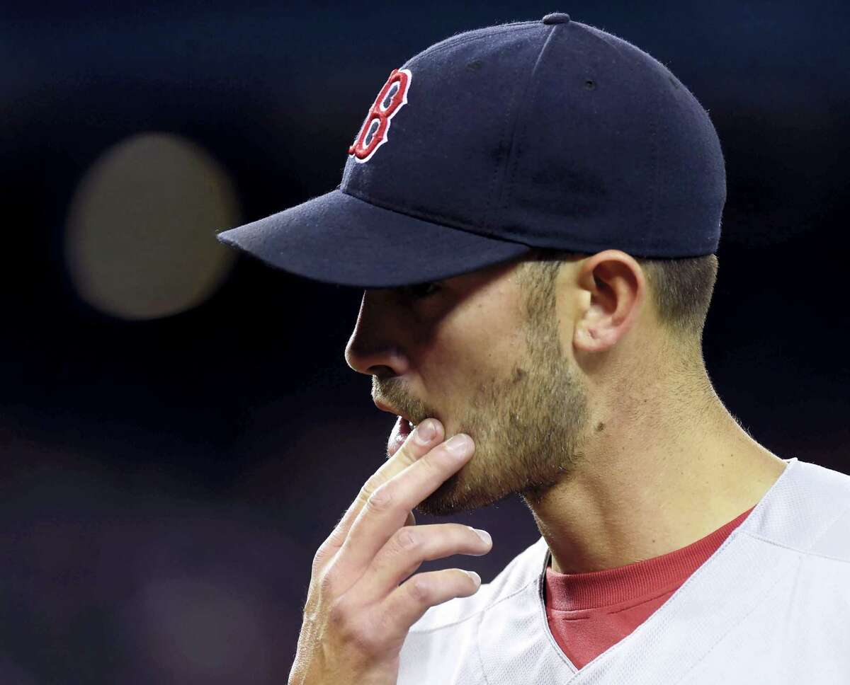 Boston Red Sox' starting pitcher Rick Porcello reacts as he walks off the mound after giving up a two-run home run to Toronto Blue Jays' Jose Bautista during the first inning of a baseball game in Toronto, Saturday, April 9, 2016. (Frank Gunn/The Canadian Press via AP) MANDATORY CREDIT