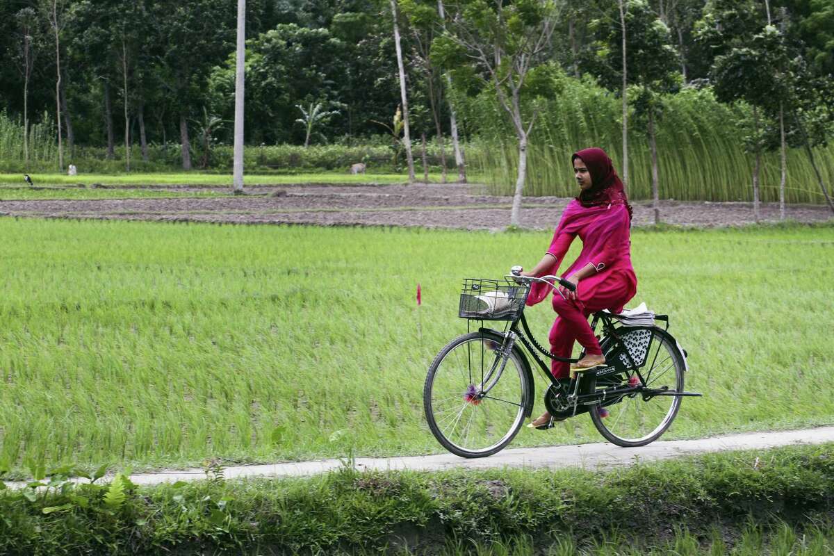 A girl rides a cycle after Bangladesh and India officially exchanged the adversely possessed enclaves at Dashiarchhara in in Kurigram district, 240 kilometers (150 miles) north of Dhaka, Bangladesh’s capital, Saturday. Tens of thousands of stateless people who were stranded for decades along the poorly defined border between India and Bangladesh can finally choose their citizenship, as the two countries swapped more than 150 pockets of land at the stroke of midnight Friday to settle the demarcation line dividing them.