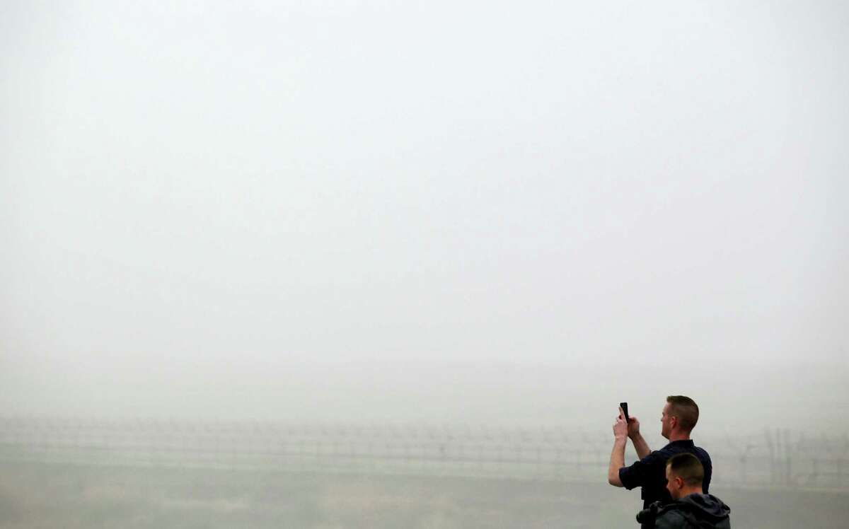 Visitors take photos on a foggy day at the Imjingak Pavilion near the border village of the Panmunjom in Paju, South Korea, Saturday, April 9, 2016. North Korea said Saturday it has successfully tested a new intercontinental ballistic rocket engine that will give it the ability to stage nuclear strikes on the United States.